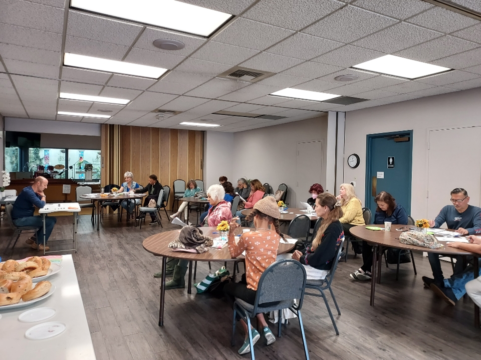 Image shows workshop attendees and Johnny Sage in the fellowship hall.