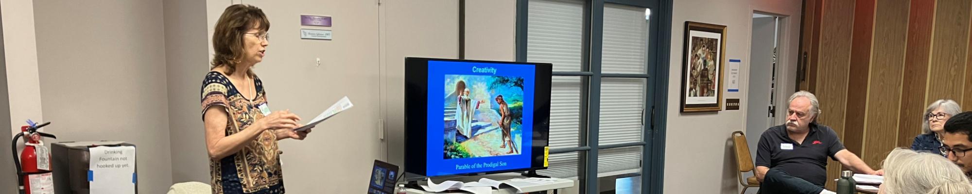 Image shows facilitator Kare Castle Cornford leading a group discussion.