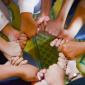 Image shows hands of people with different colored skin holding each other to make a circle.